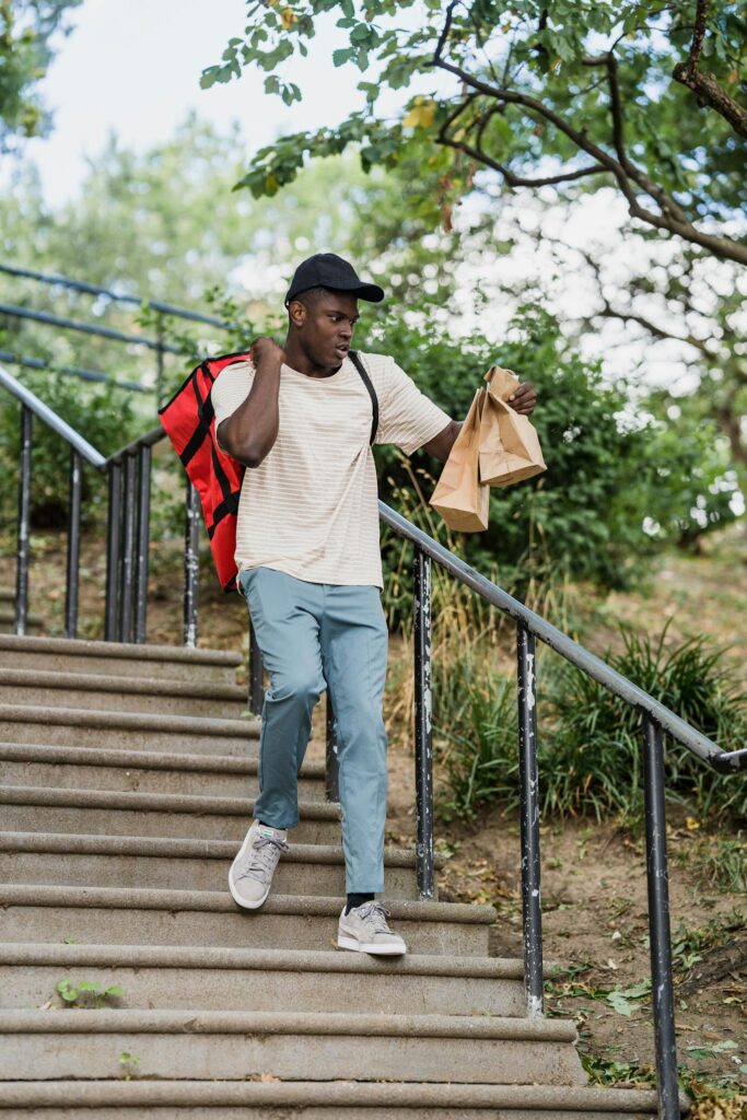 Courier with Backpack Delivering Order