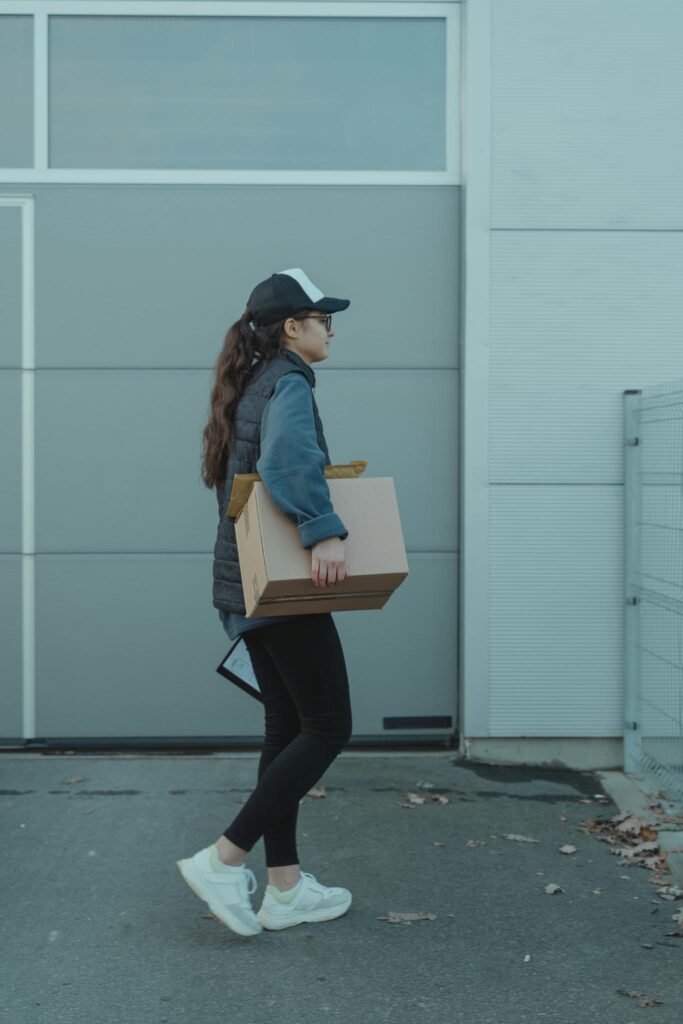 Female Courier carrying a Box